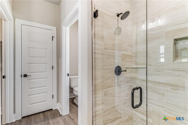 2109 Park View Dr, Marble Falls, TX 78654 - full bath featuring a shower stall, toilet, and wood finished floors