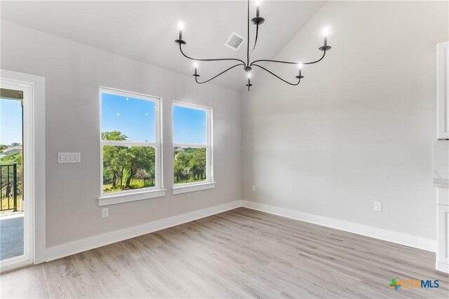 2109 Park View Dr, Marble Falls, TX 78654 - unfurnished dining area with a chandelier, healthy amount of natural light, and light wood-style flooring