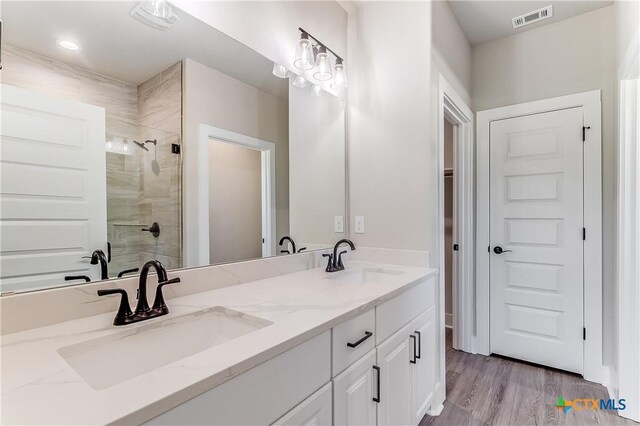 2109 Park View Dr, Marble Falls, TX 78654 - bathroom featuring a stall shower, double vanity, and wood finished floors