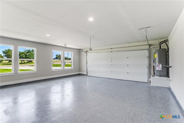 2109 Park View Dr, Marble Falls, TX 78654 - garage featuring water heater, baseboards, and recessed lighting