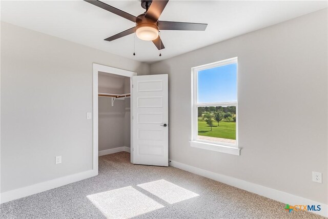 2109 Park View Dr, Marble Falls, TX 78654 - unfurnished bedroom with light carpet, baseboards, a closet, and a ceiling fan