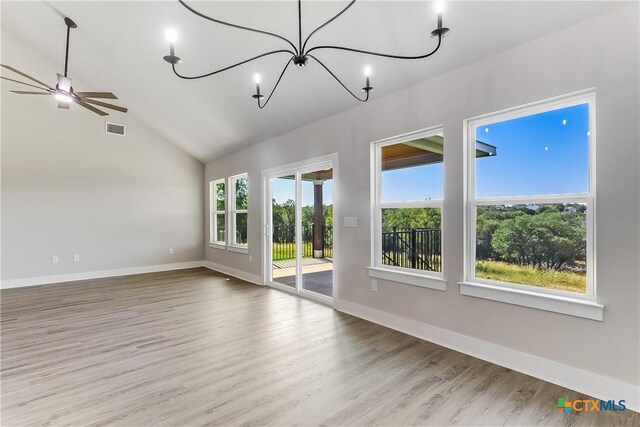 2109 Park View Dr, Marble Falls, TX 78654 - empty room with a chandelier, wood finished floors, vaulted ceiling, baseboards, and a ceiling fan