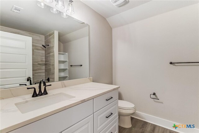 2109 Park View Dr, Marble Falls, TX 78654 - full bath featuring vanity, toilet, wood finished floors, a shower, and vaulted ceiling