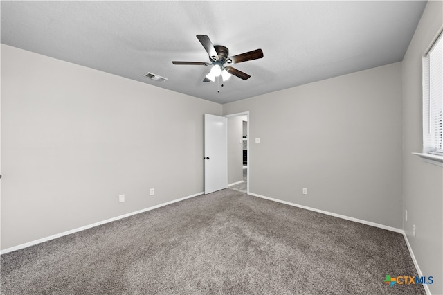 unfurnished room featuring ceiling fan, carpet floors, and a healthy amount of sunlight