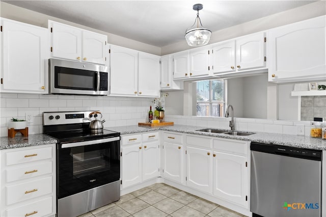 kitchen featuring white cabinets, light tile patterned flooring, sink, and stainless steel appliances