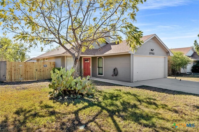 ranch-style home with a front lawn and a garage