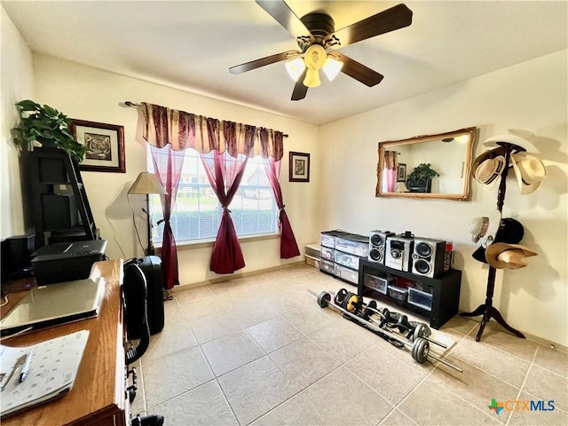 office area featuring tile patterned flooring, a ceiling fan, and baseboards