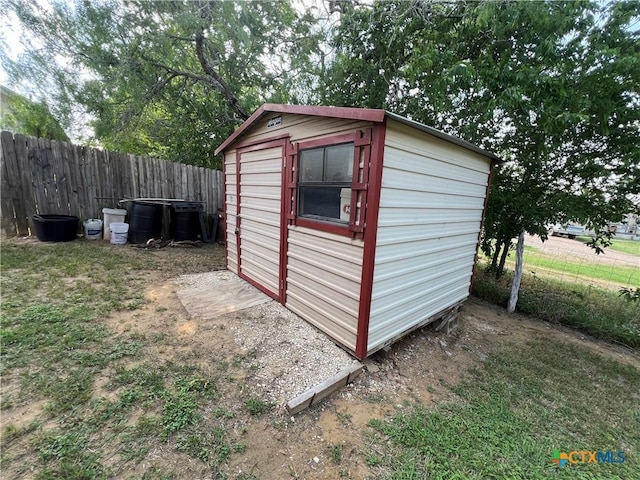 view of shed with fence