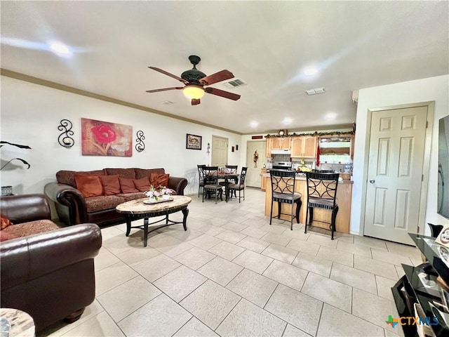 living room featuring ceiling fan, crown molding, recessed lighting, and light tile patterned floors