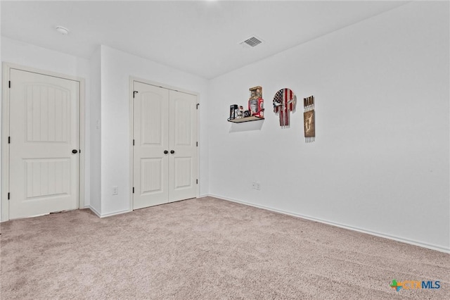 unfurnished bedroom featuring a closet and carpet