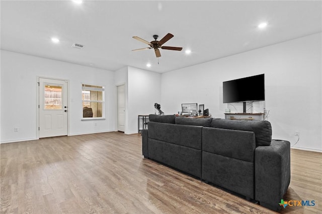 living room featuring ceiling fan and light hardwood / wood-style floors