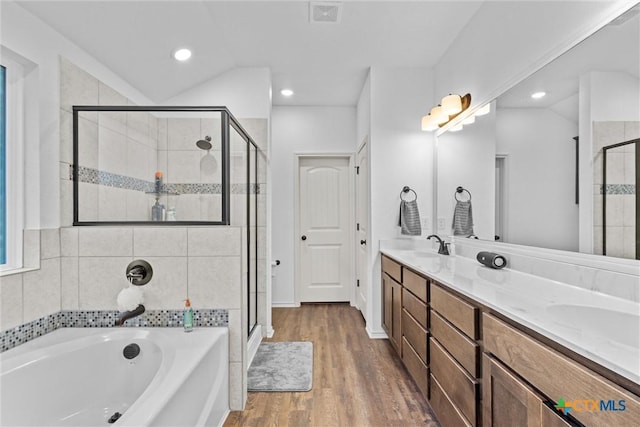 bathroom featuring vanity, independent shower and bath, and hardwood / wood-style flooring