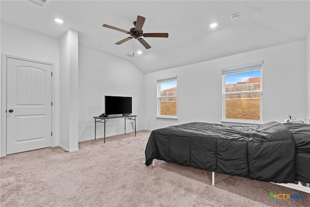 carpeted bedroom featuring ceiling fan and vaulted ceiling