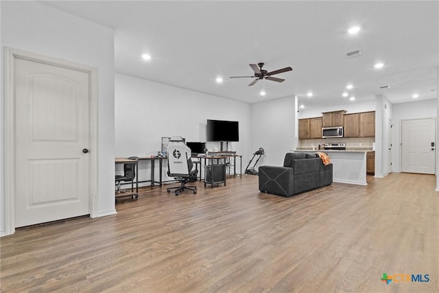 living room with ceiling fan and light wood-type flooring