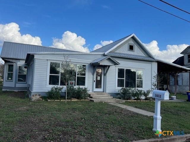 1612 Saint Peter St, Gonzales, TX 78629 - bungalow with a front lawn and metal roof