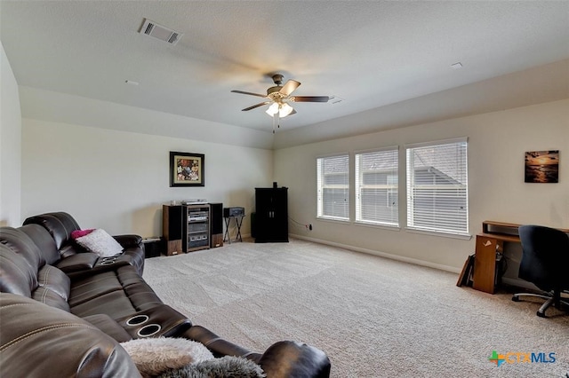 carpeted living room featuring ceiling fan