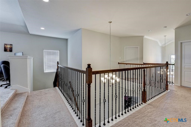 hall featuring ornamental molding and light colored carpet