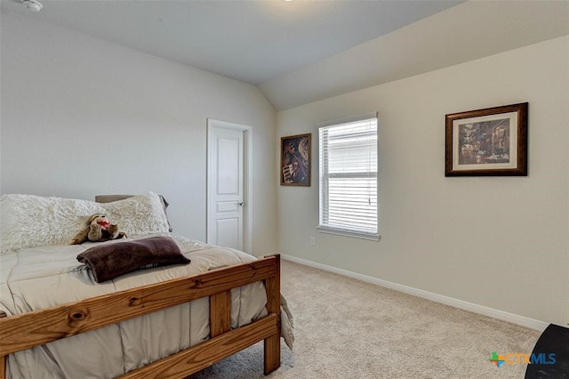 bedroom featuring light colored carpet and vaulted ceiling