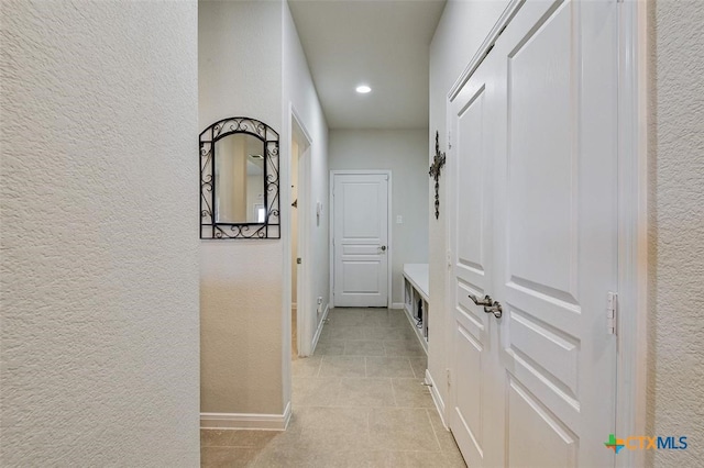 corridor featuring light tile patterned flooring