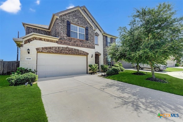 view of front of home featuring a front lawn and a garage