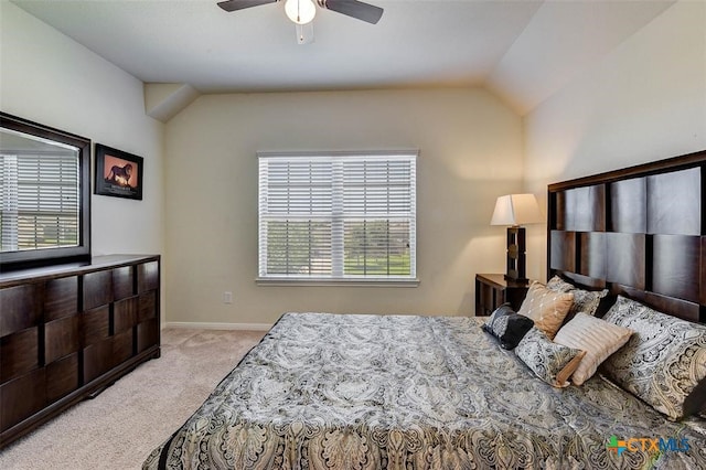 carpeted bedroom with ceiling fan and vaulted ceiling