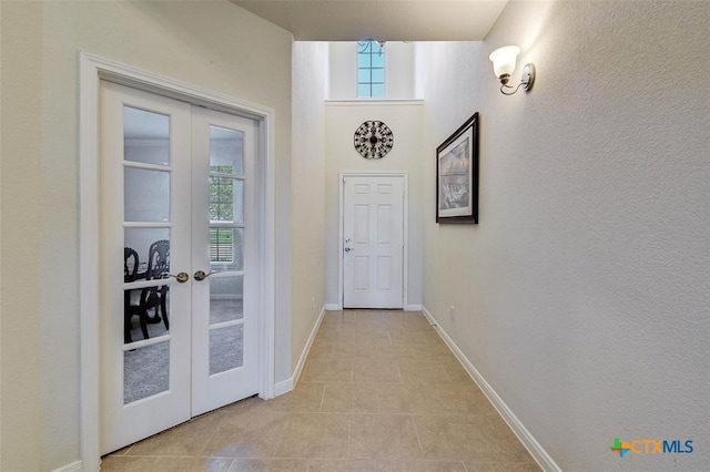 doorway to outside with french doors and light tile patterned floors