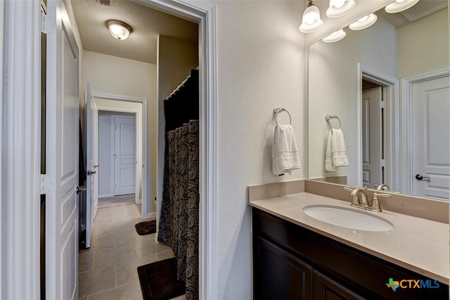 bathroom with vanity and a textured ceiling