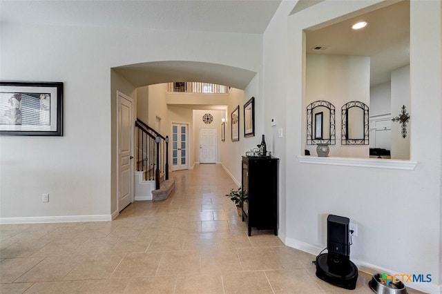 hall featuring light tile patterned floors