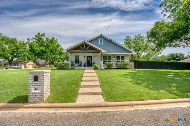 craftsman-style home with a front lawn and covered porch