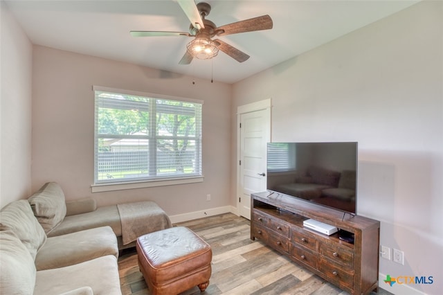 living room featuring light hardwood / wood-style flooring and ceiling fan