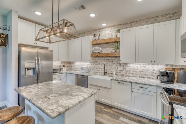 kitchen with white cabinetry, appliances with stainless steel finishes, and sink