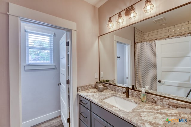 bathroom featuring vanity and a shower with curtain