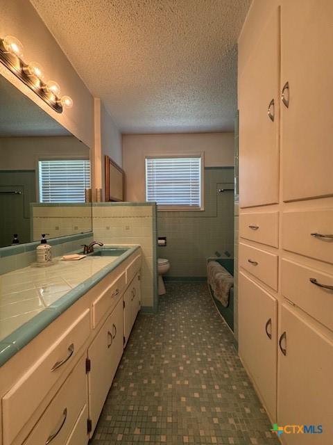 2410 Robin Rd, Temple, TX 76502 - bathroom with vanity and a textured ceiling