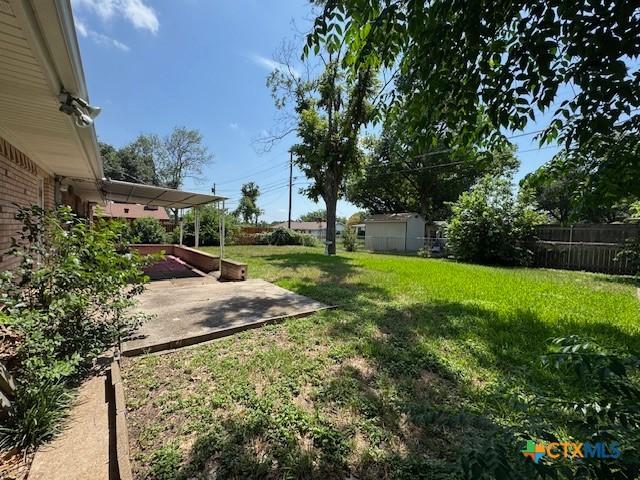 2410 Robin Rd, Temple, TX 76502 - fenced backyard with a patio area