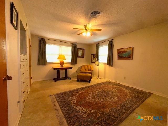2410 Robin Rd, Temple, TX 76502 - sitting room featuring a ceiling fan, a textured ceiling, healthy amount of natural light, and carpet floors