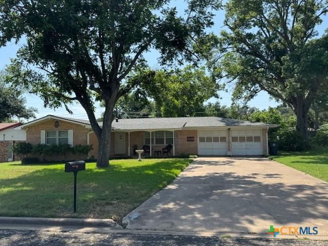 2410 Robin Rd, Temple, TX 76502 - ranch-style home with concrete driveway, a front lawn, and a garage