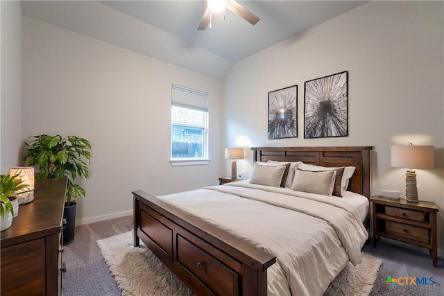 bedroom with ceiling fan, carpet floors, and vaulted ceiling