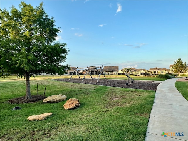 surrounding community featuring a playground and a lawn