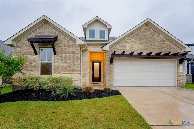 view of front of house with a garage and a front lawn