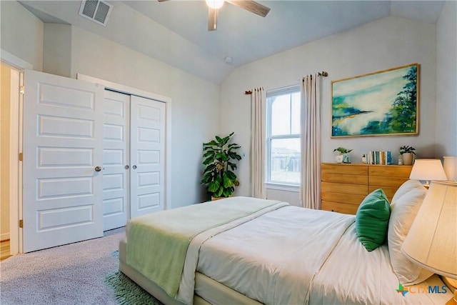 carpeted bedroom featuring ceiling fan, a closet, and vaulted ceiling