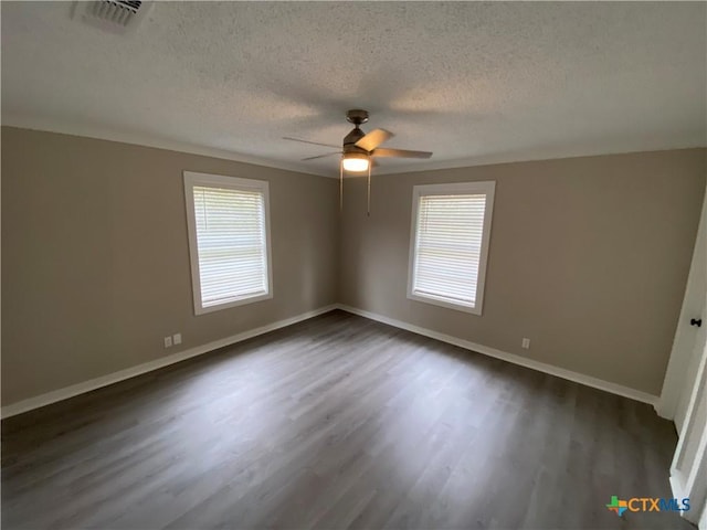 unfurnished bedroom with multiple windows, baseboards, and dark wood-style flooring