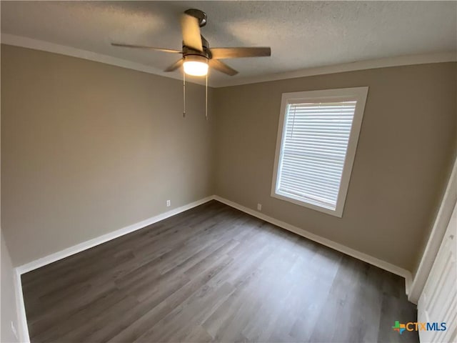 unfurnished bedroom featuring crown molding, a textured ceiling, baseboards, and dark wood-type flooring