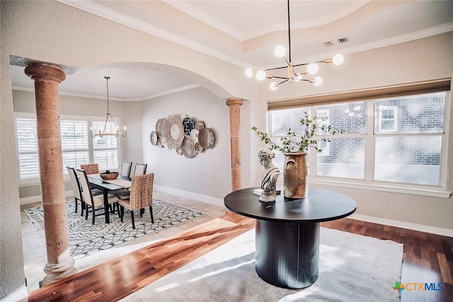 2788 Morning Moon, New Braunfels, TX 78132 - dining room featuring a chandelier, ornate columns, crown molding, arched walkways, and plenty of natural light