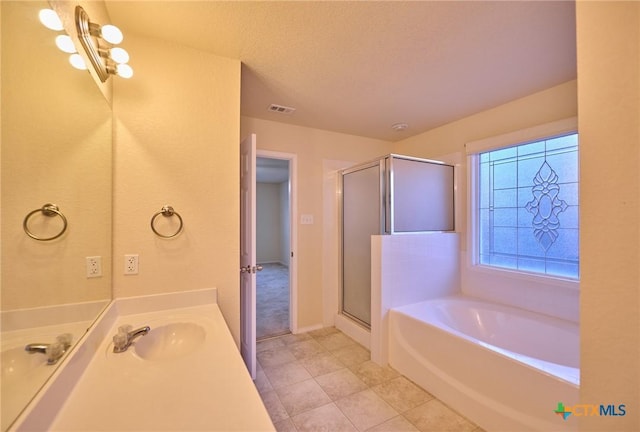 bathroom featuring a textured ceiling, vanity, tile patterned floors, and independent shower and bath