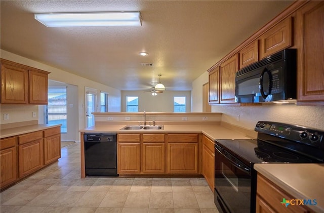 kitchen with black appliances, sink, ceiling fan, a textured ceiling, and kitchen peninsula