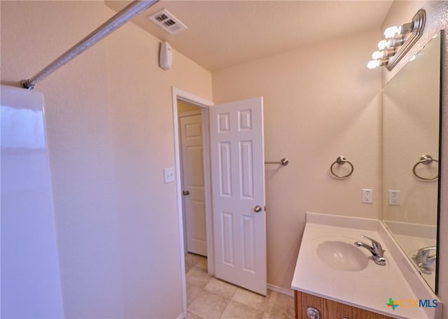 bathroom with tile patterned flooring and vanity