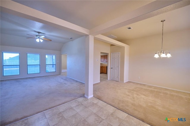 carpeted empty room with ceiling fan with notable chandelier and lofted ceiling