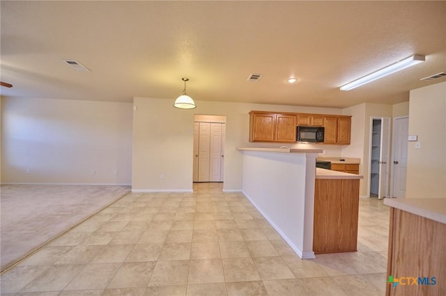 kitchen with pendant lighting, kitchen peninsula, and a textured ceiling