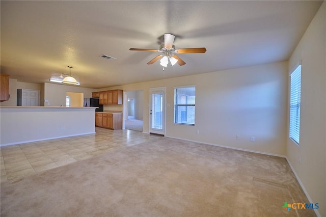 unfurnished living room with ceiling fan and light colored carpet