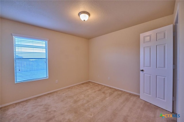 carpeted spare room featuring a textured ceiling